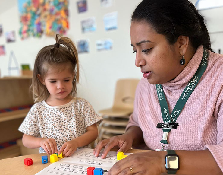 preschool teacher working with a student