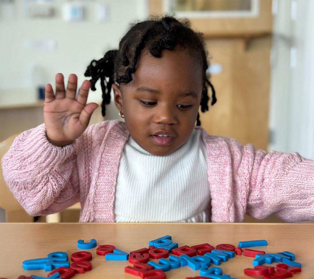 little girls playing with block letters