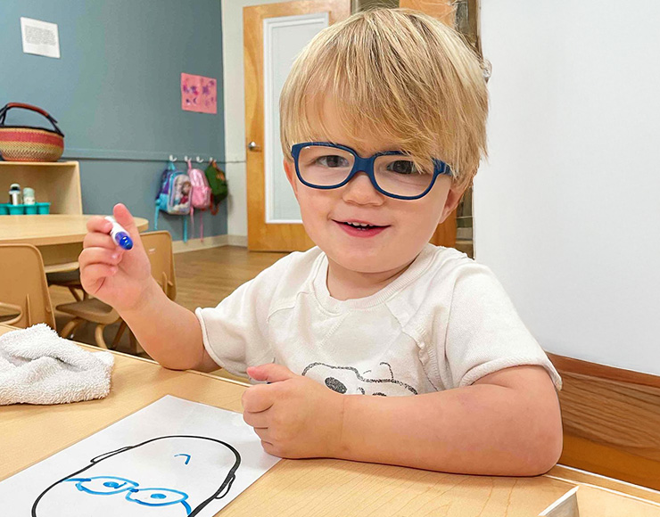 preschooler drawing a picture of himself