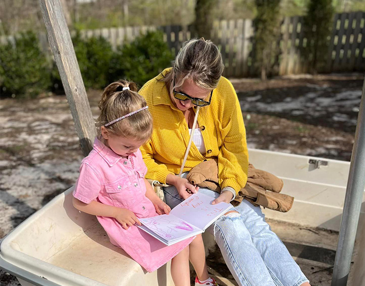 Mom reading to her young daughter